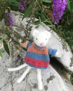 mouse sweater on rock purple flowers