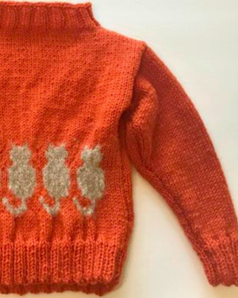 Featured Image for cat sweater knitting pattern orange sweater with grey cats across sweater