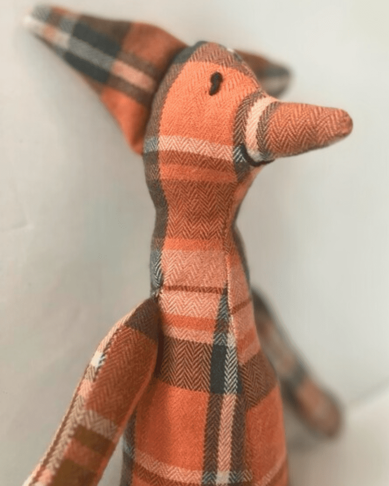 orange flannel toy fox on a white background