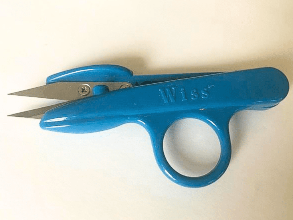 blue wiss thread snips on white background