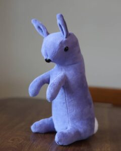 handmade purple velveteen rabbit on a brown table