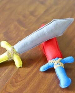colorful handmade felt swords laying on a table