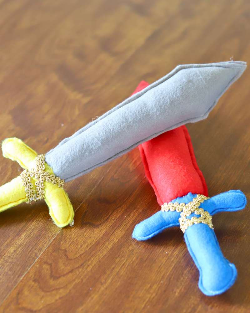 colorful handmade felt swords laying on a table